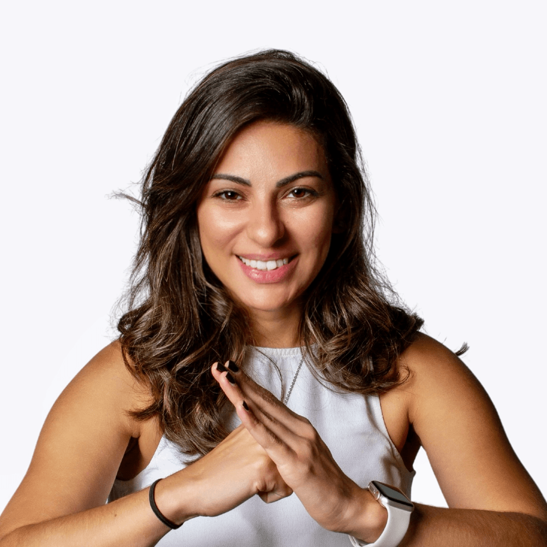 Photo of Ari Pereira smiling and showing connected hand gesture